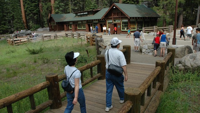 People walk toward a rustic building