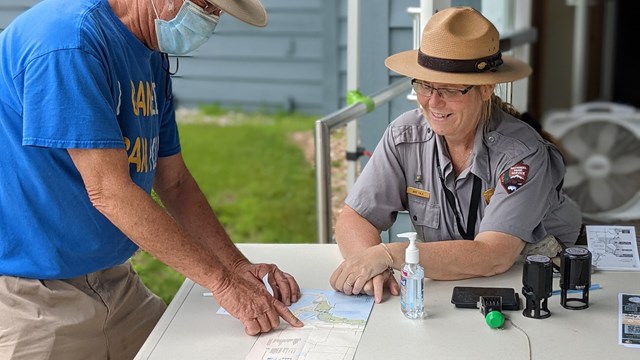 A ranger helping a visitor with a question