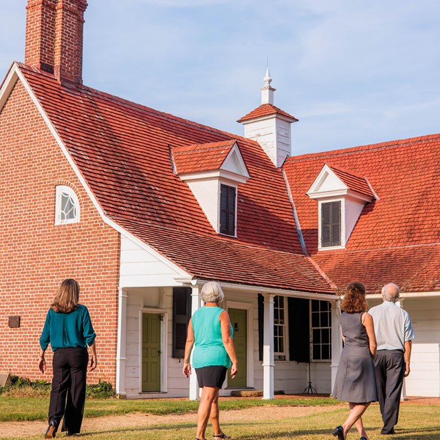 Picture of the Sotterley house with visitors walking up to it. Photo credit to Historic Sotterley.