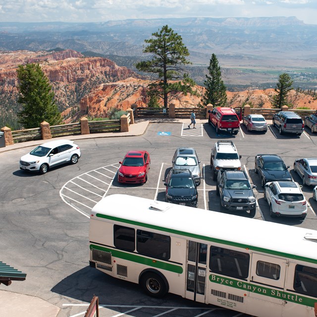 An overhead photo of a parking lot with a shuttle bus in the foreground.