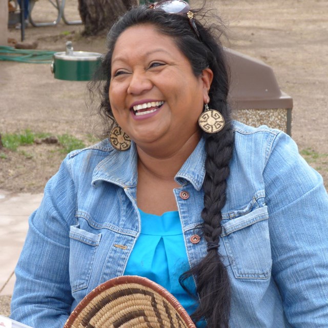 woman laughing in front of baskets