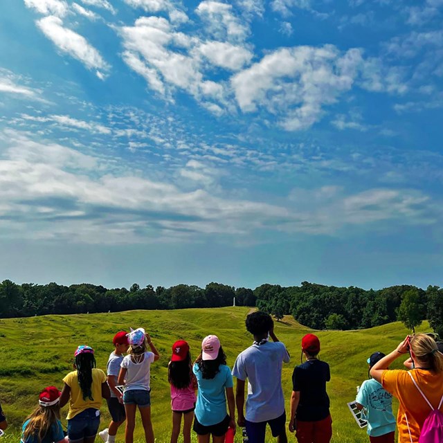 A group of students look out into the fields.