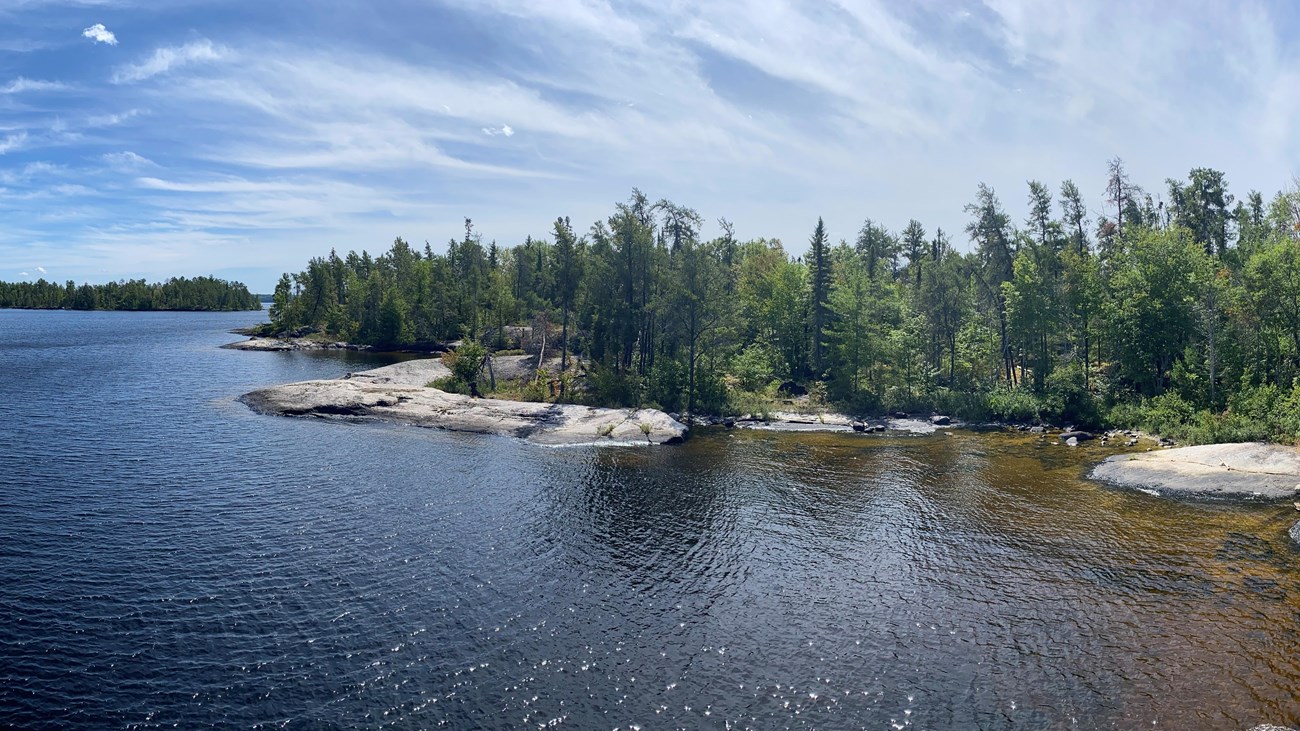 View of a large lake with rocky shorelines. 