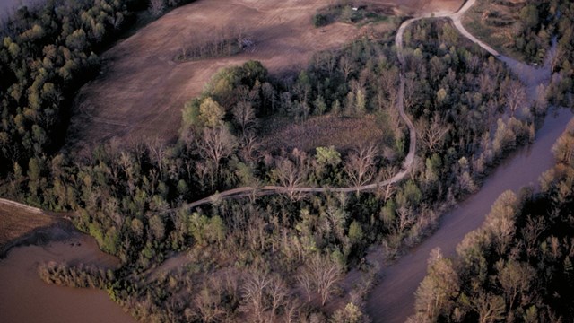 Arial view of Arkansas Post National Memorial that shows a river surrounded by trees.
