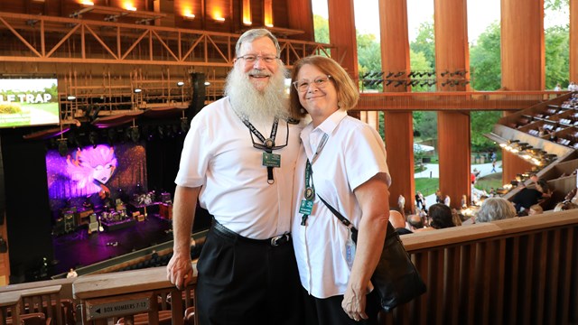 A two volunteer ushers pose inside the Filene Center. 