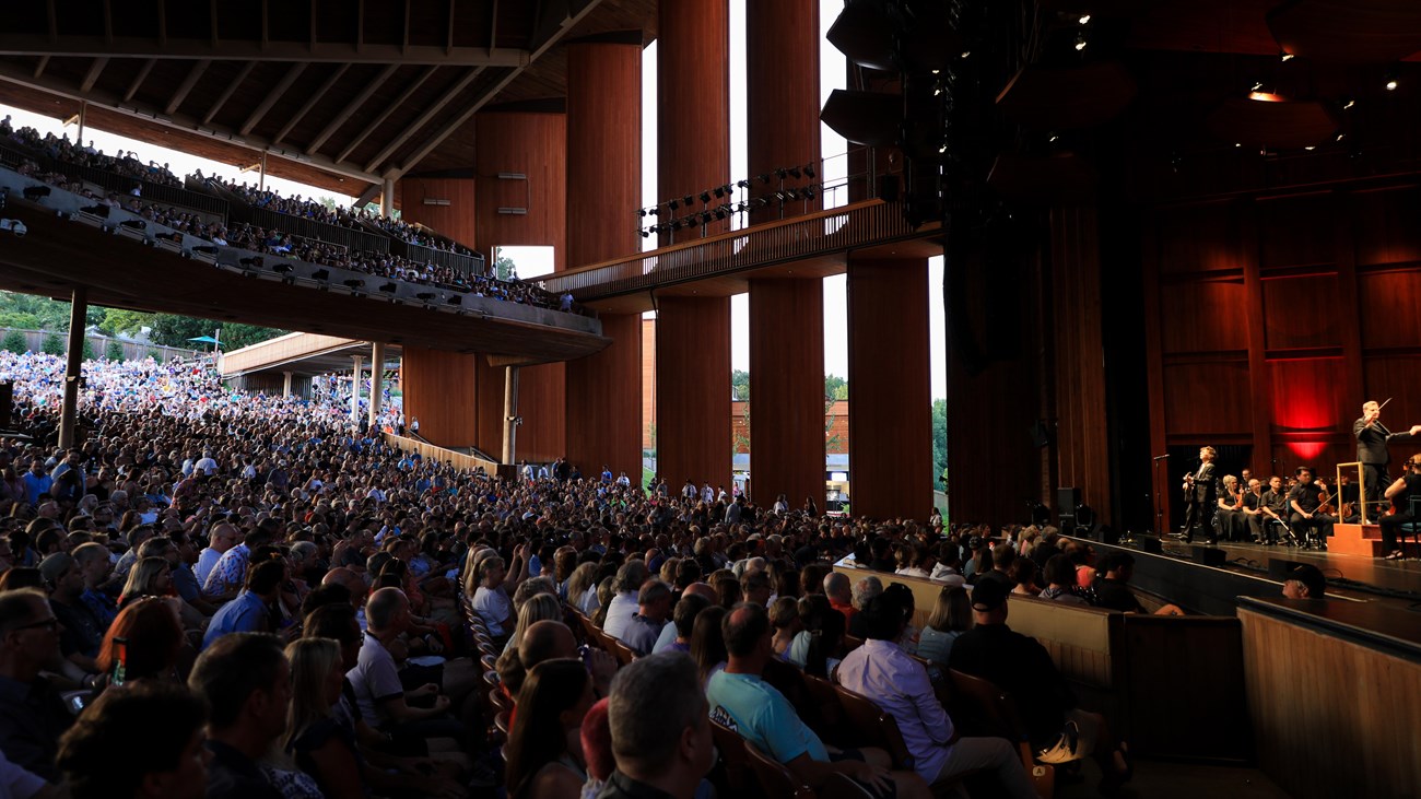 The seating area of the Filene Center with seated patrons