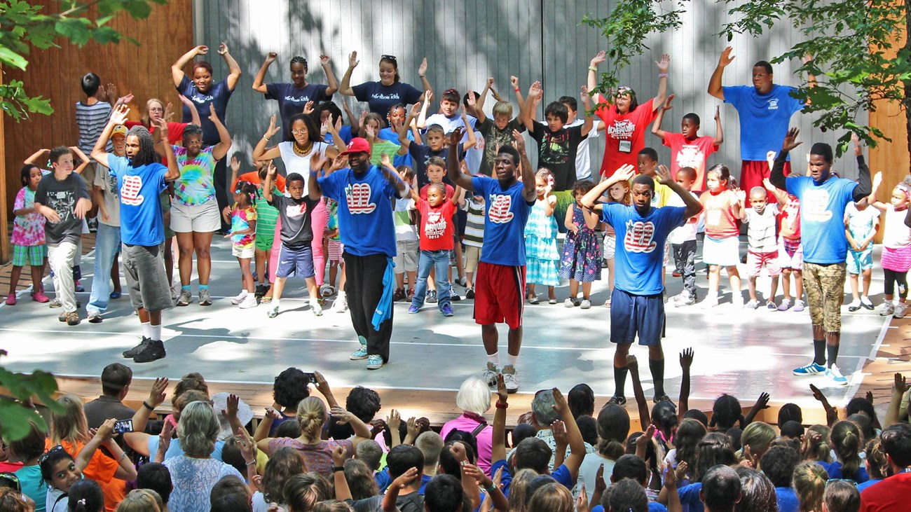 A dance performance on stage in front of an audience. 