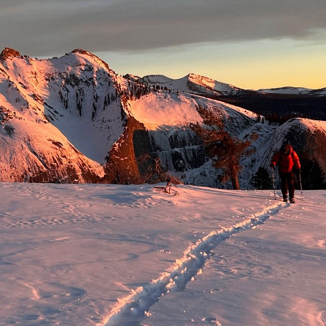 Skier on snowy side of a mountain