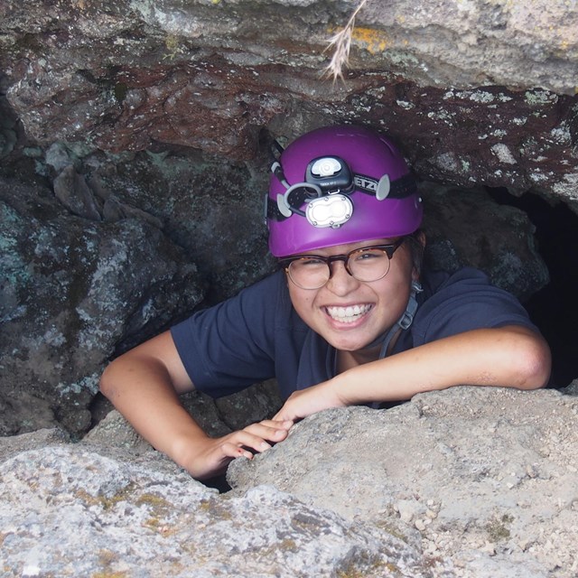 person in cave opening