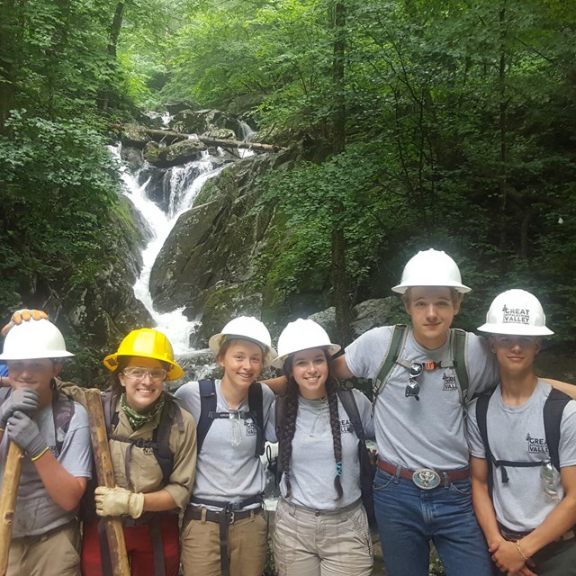 Corps members take a break from clearing trails. 