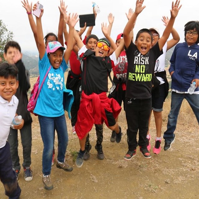 Several youth jumping for joy