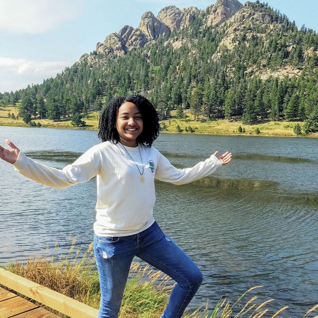 intern by lake with mountain in background