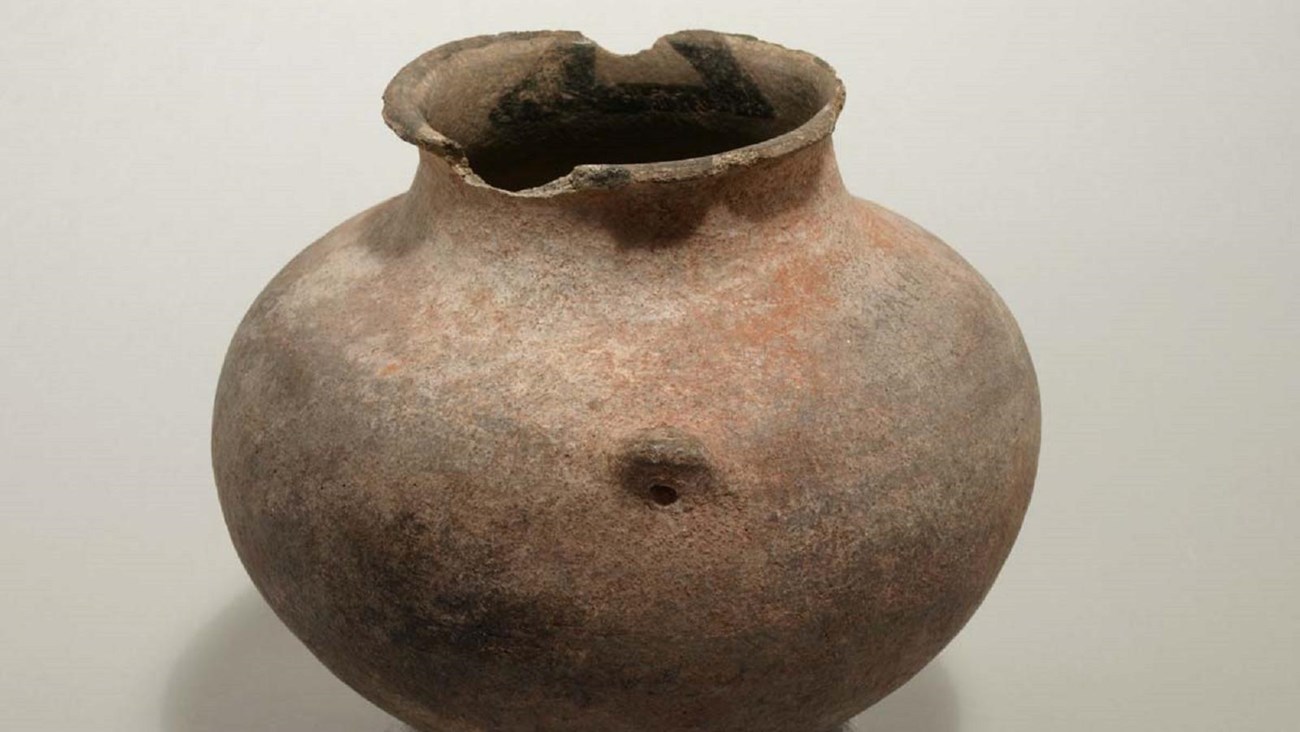 A historic pot photographed inside the park museum building.