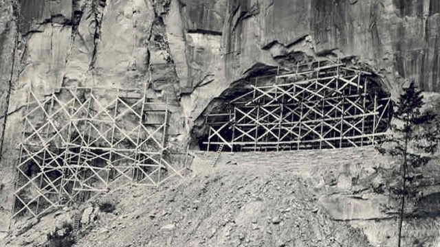 Wood supports an opening in rock above a canyon