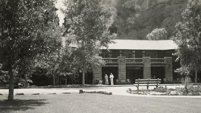 A building with two people standing before it.