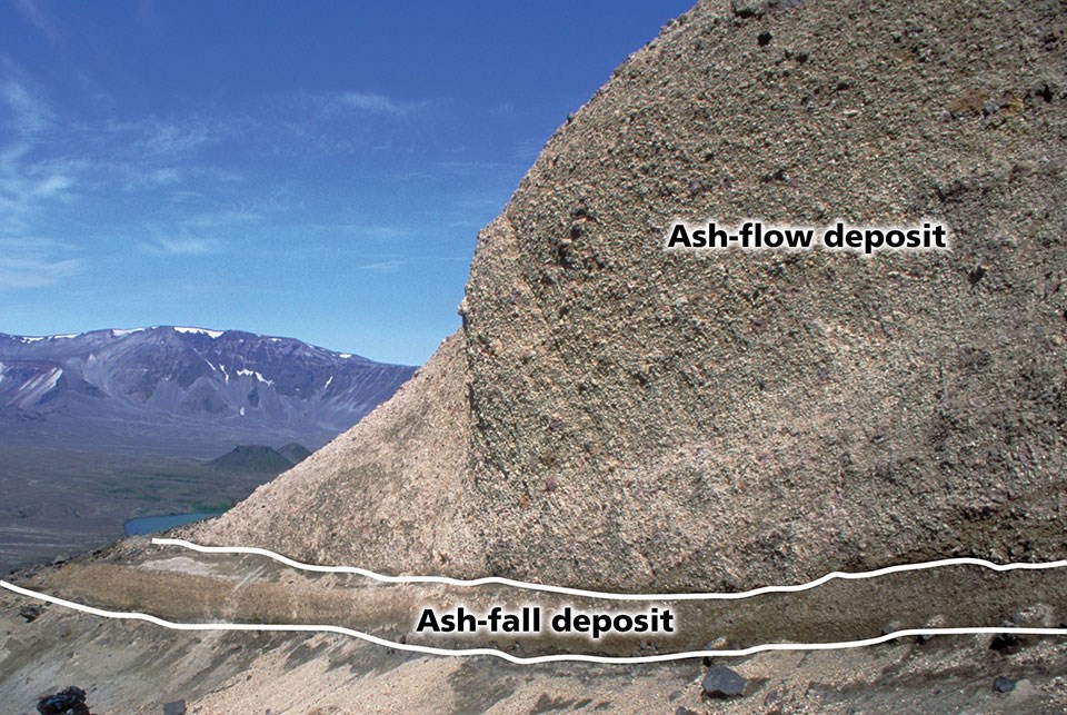 Photo of a rocky bluff with different layers of ash deposits