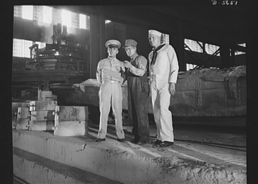 Sepia poster of three white men, left in army uniform, center in rail road cap with tube looped over his shoulder, right in navy uniform. Text: "Men working together!"