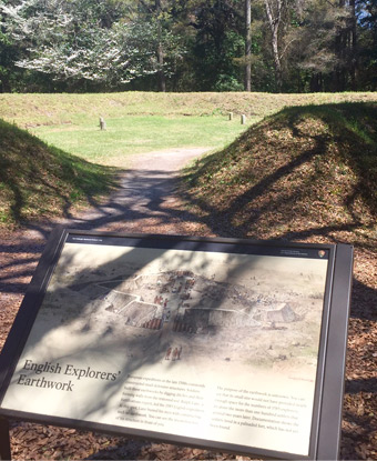 Sunlit earthwork with wayside exhibit