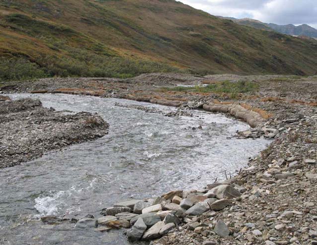 a shall creek flowing through a rocky valley