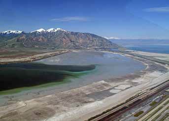 aerial view of mountains behind a large pond