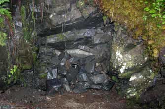 A mine opening covered by gray material