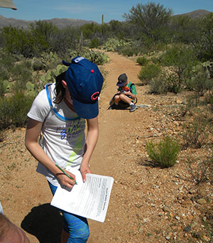 Talia and younger brother Nate working on Junior Ranger books