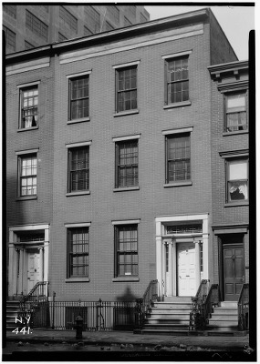 Outside the John V. Gridley House, a three-story brick structure in a row of similar buildings