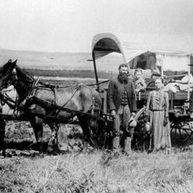 Photo of a young family with their covered wagon and team of horses. Photo of a young family with their covered wagon and team of horses.