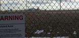 A view toward the Delta-09 nuclear missile silo from the fence; a warning sign is prominent in the foreground