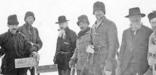 historic photo of men with gear at the Alaska-British Columbia border in the snow