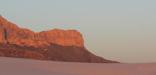 The Western Escarpment of the Guadalupes rises above the white gypsum sands of the desert floor.