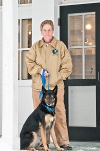 Paw Patrol Volunteer Ruth and dog Roxy stand in front of the Boston Store Visitor Center