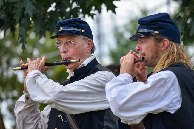 reenactors depicting Civil War musicians playing fifes