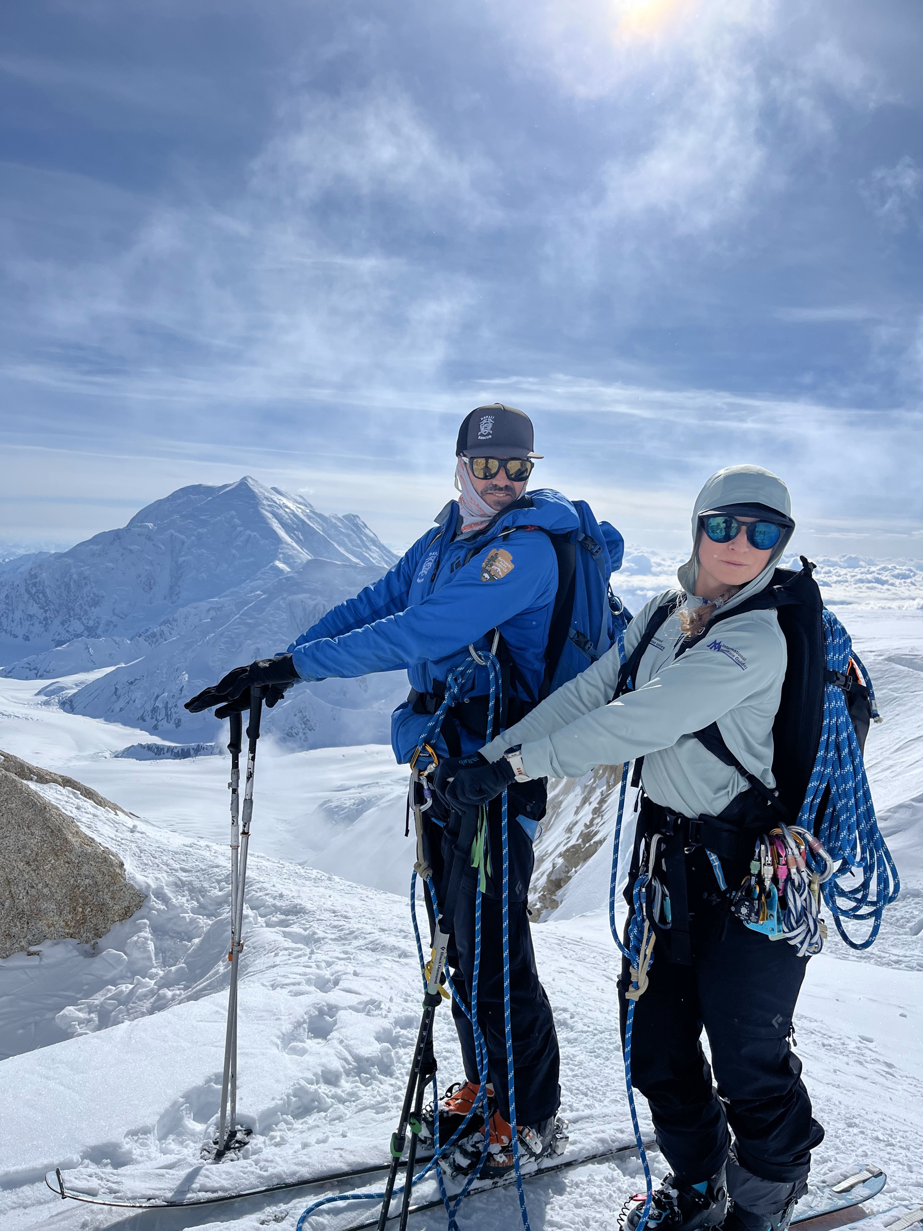 Patrol 3 Team Photo C 2 rangers stand together on skis with winter gear in front of a snow covered mountain