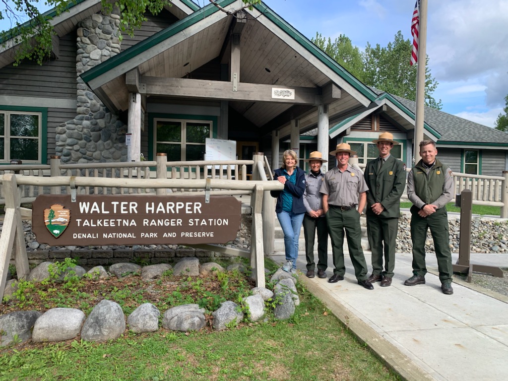 Senator Lisa Murkowski poses with rangers in front of ranger station