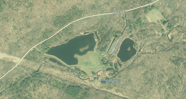 An aerial view of a wooded area with roads highlighted.