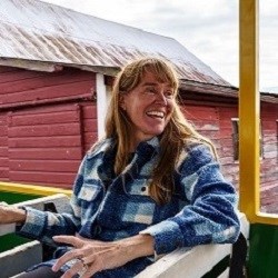 Young woman on tractor smiling