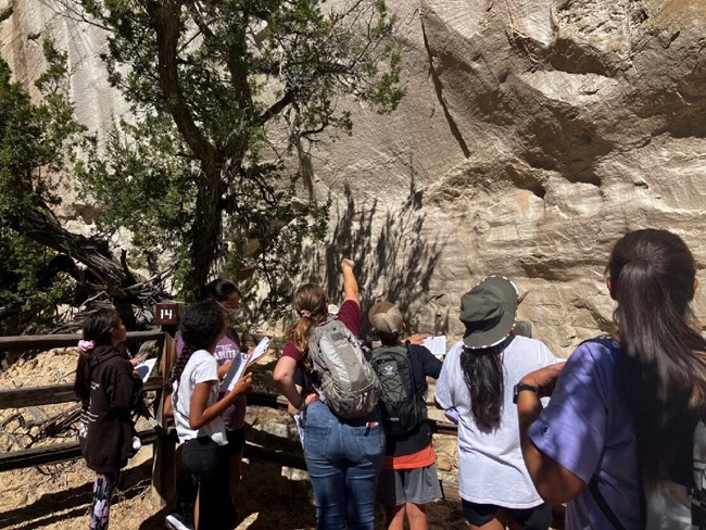 Students and teacher looking at inscriptions on El Morro