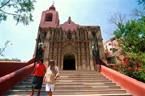 two people walking with cathedral in the back