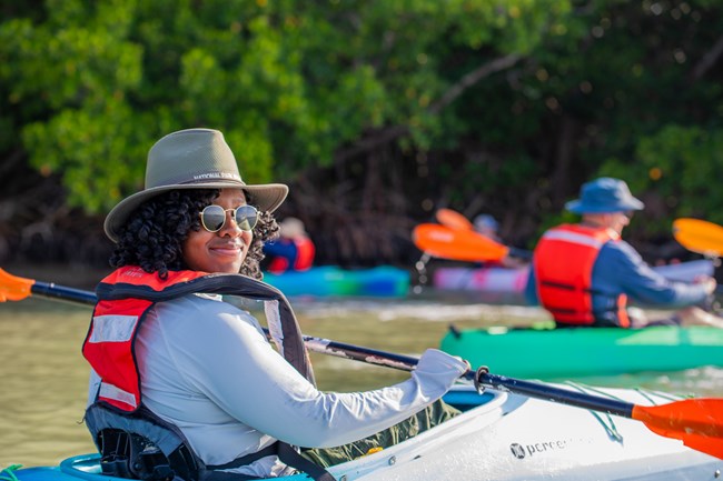 A Ranger smiling while paddllling in Flamingo.