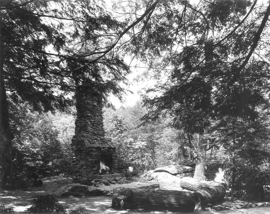 The large outdoor fireplace and chimney.
