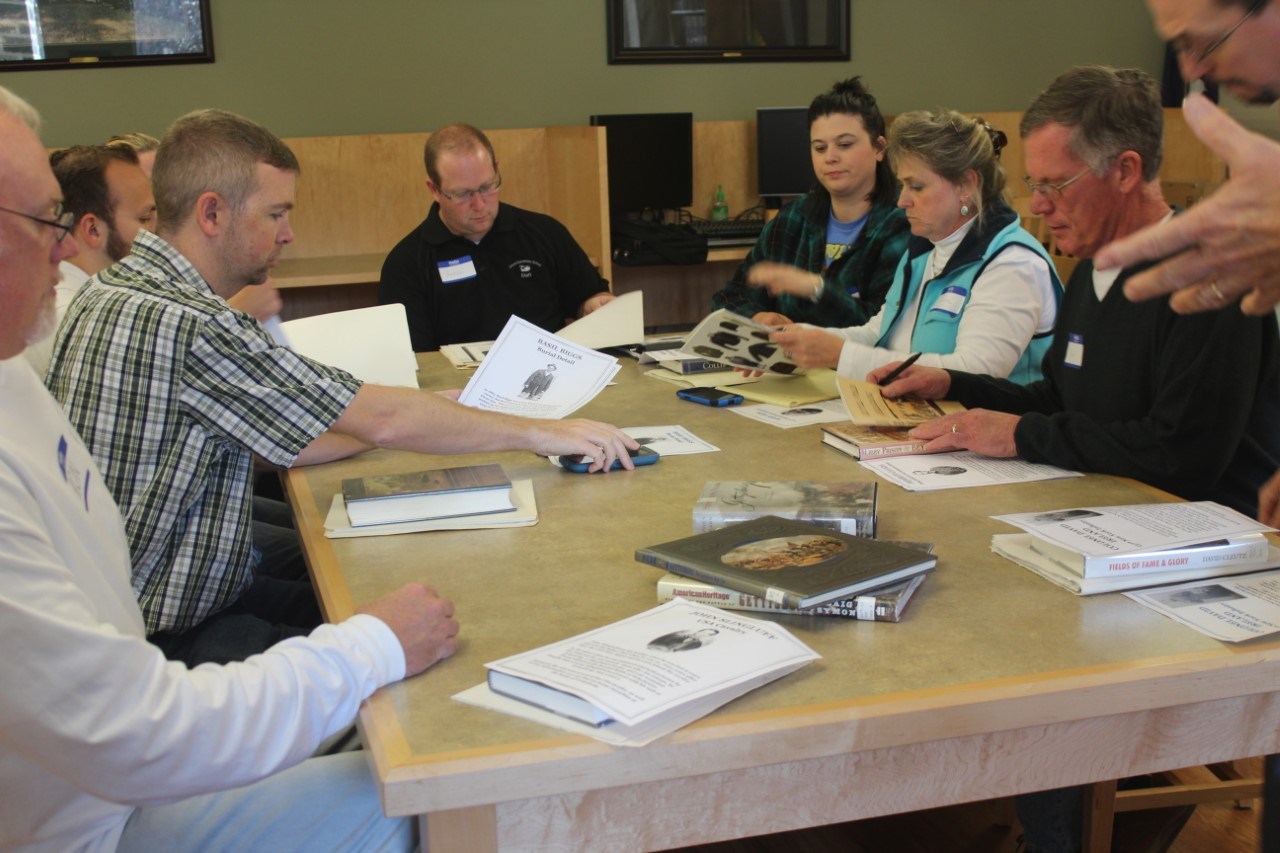 Teachers sitting at a table examining historic documents