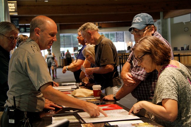 Gettysburg Museum and Visitor Center Information Desk where National Park Service staff is helping visitors.