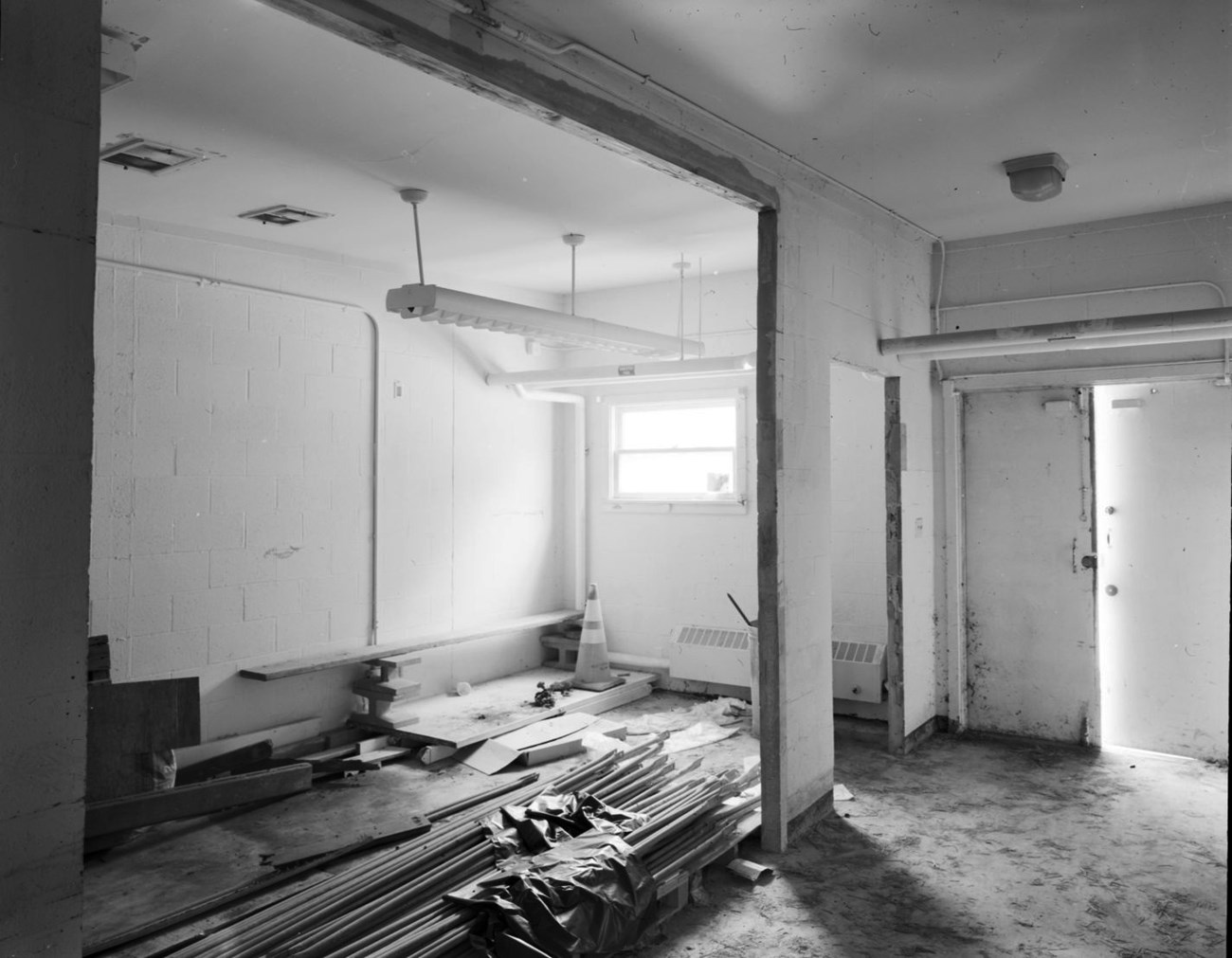 a building hallway with lumber stacked in the middle