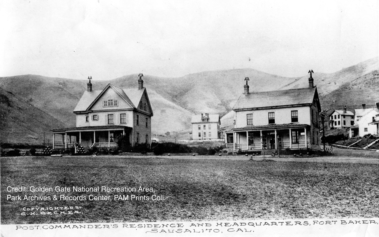 two story wood frame buildings with cannon balls on front lawn