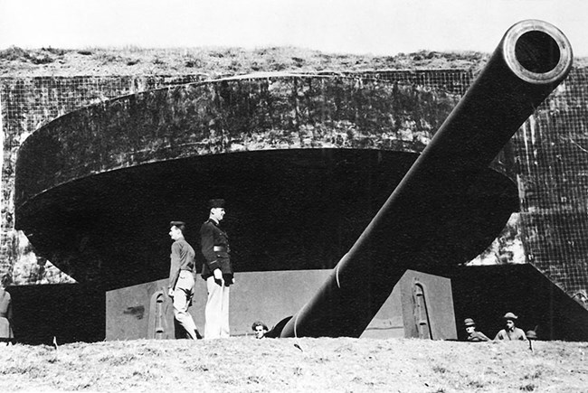 soldiers working around a very large gun