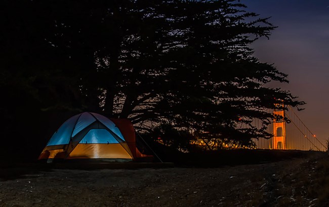 Tent on hill overlooking the Golden Gate Bridge.