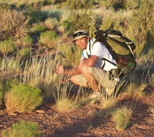 Deon Ben examining grasses.