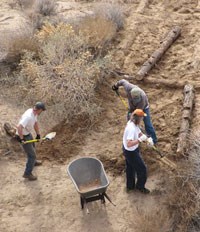 3 men rebuilding pathway to boater's camp.