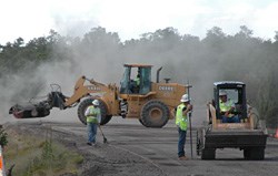 heavy equipment and workers at the site.